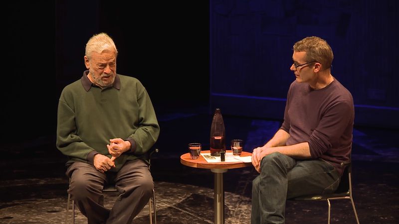 A photo of Rufus Norris & composer Stephen Sondheim sat on stage, talking to each other.