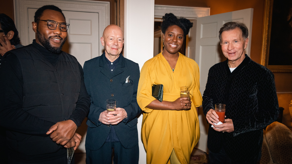 Gbolahan Obisesan, ULTZ, Sadeysa Greenaway-Bailey and John Studzinski stood in formal attire inside a grand-looking room, smiling at the camera.